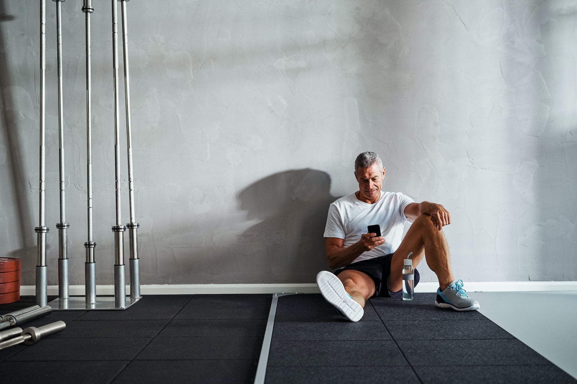 Mature man checking his messages after a health club workout