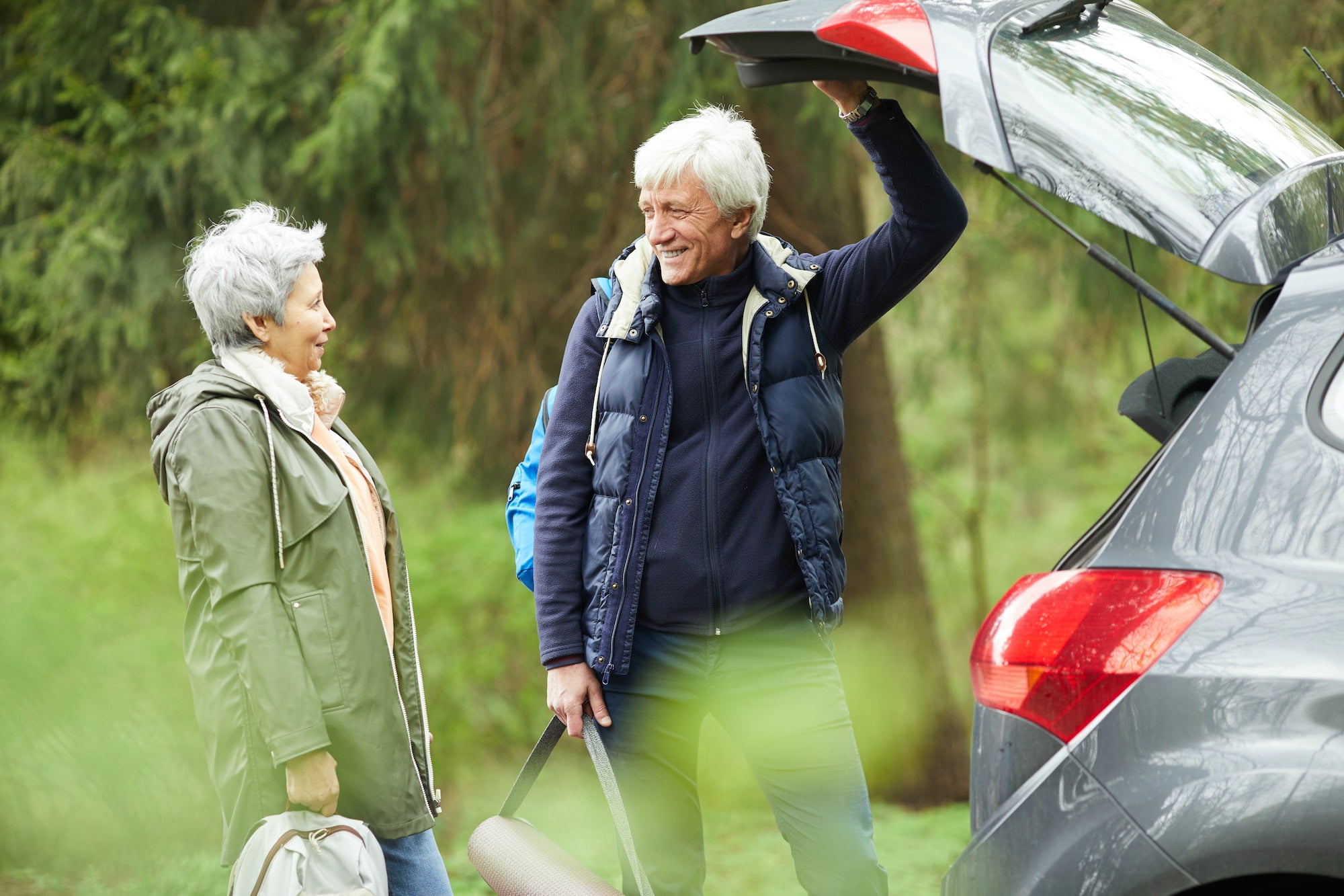 Active Senior Couple by Car