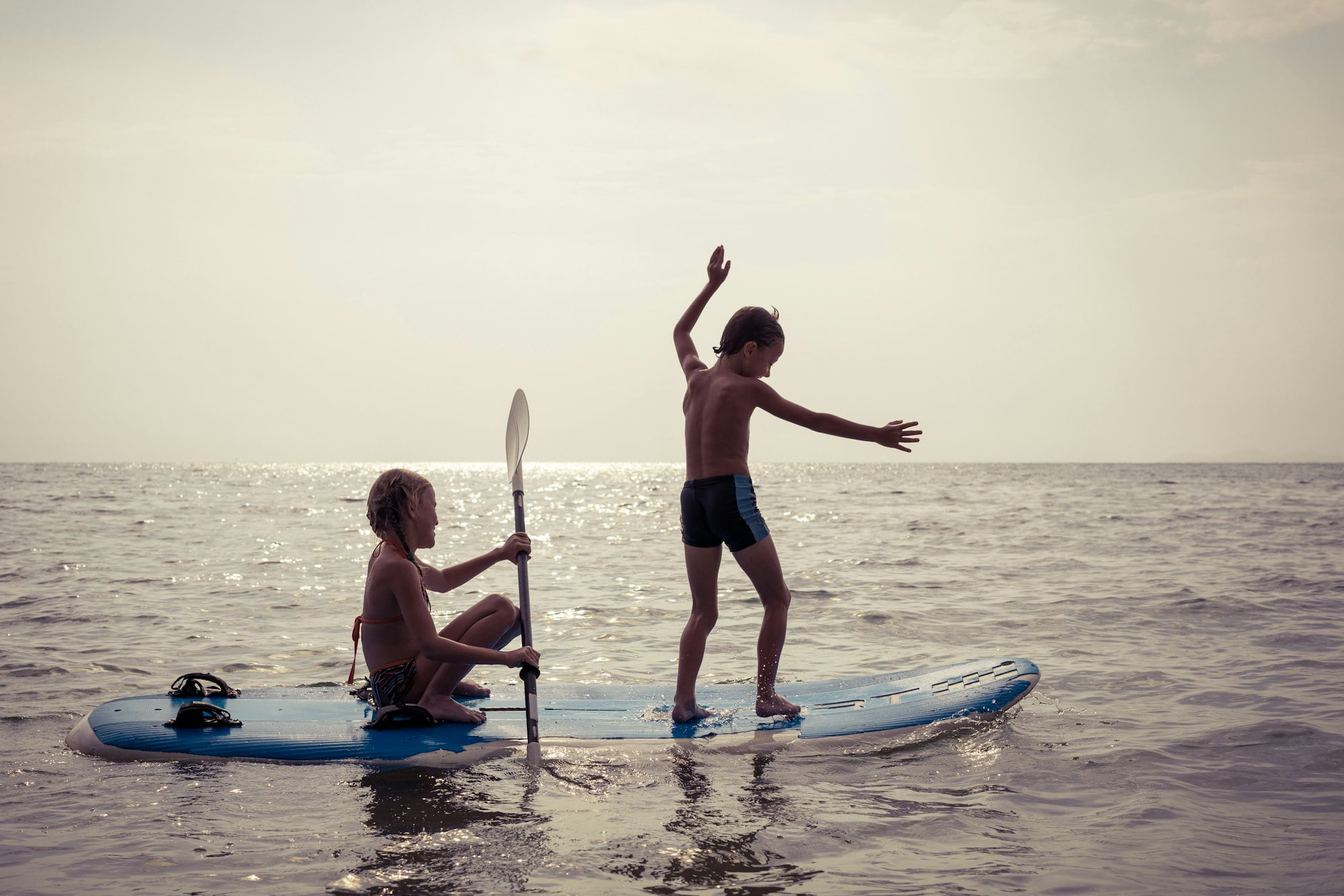 Happy children playing on the beach at the day time.