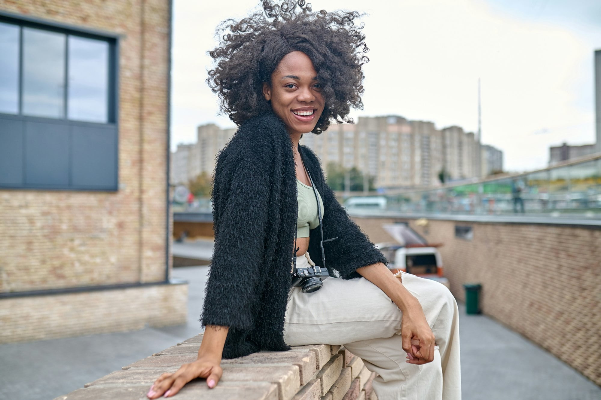 Happy young woman on a urban backgraound